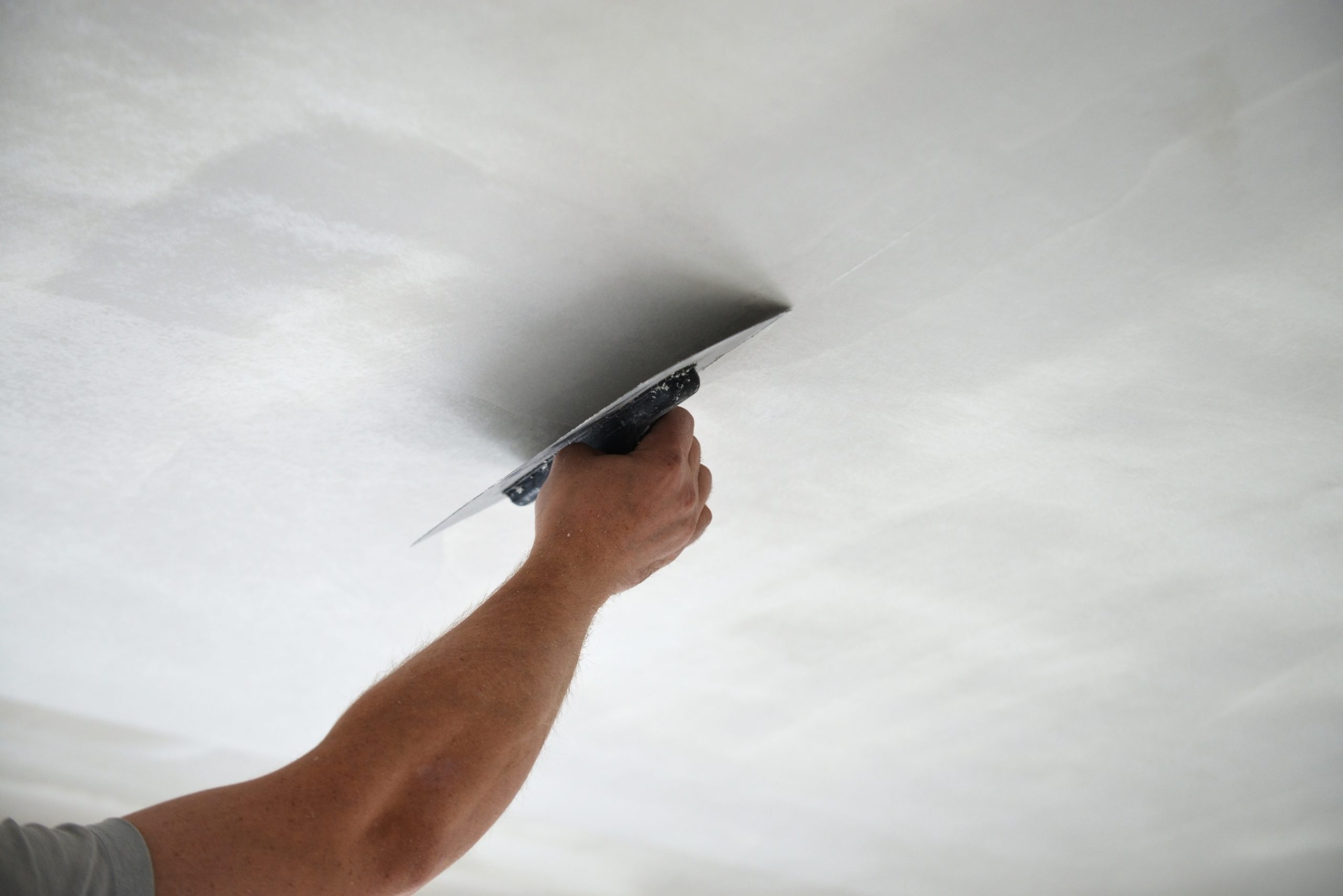 man plastering ceiling